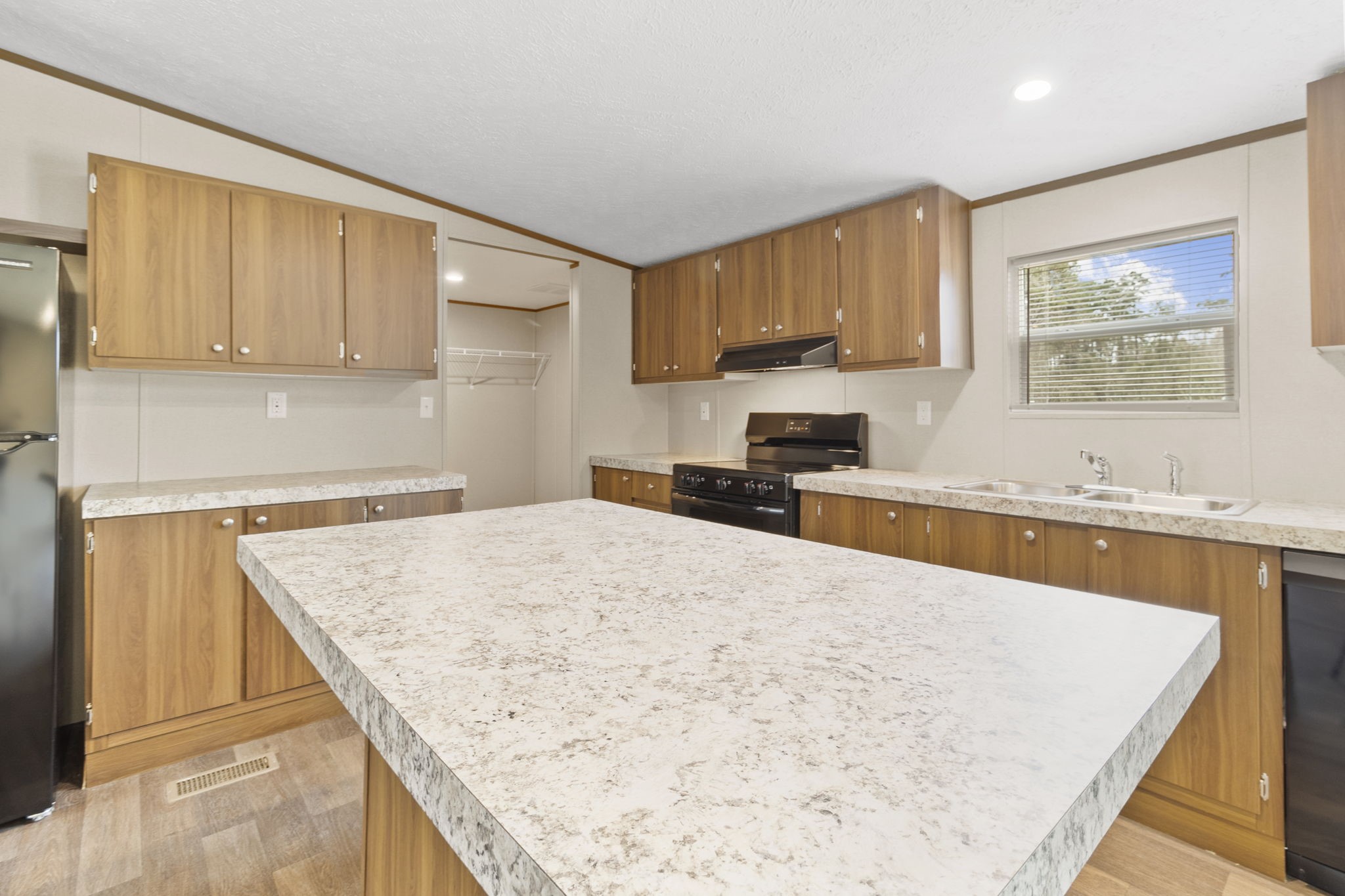 245 Rustic Way Livingston, TX 77351 - Photo 8 of 33 a large kitchen with kitchen island a sink stove and refrigerator