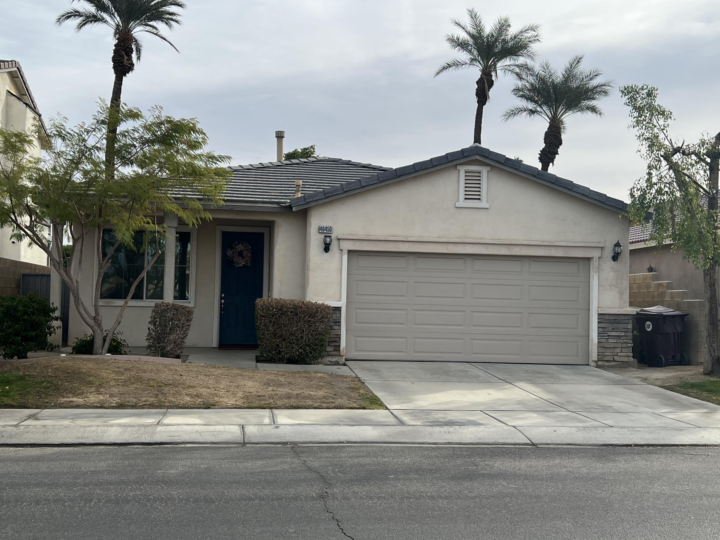 a view of a house with a yard and garage