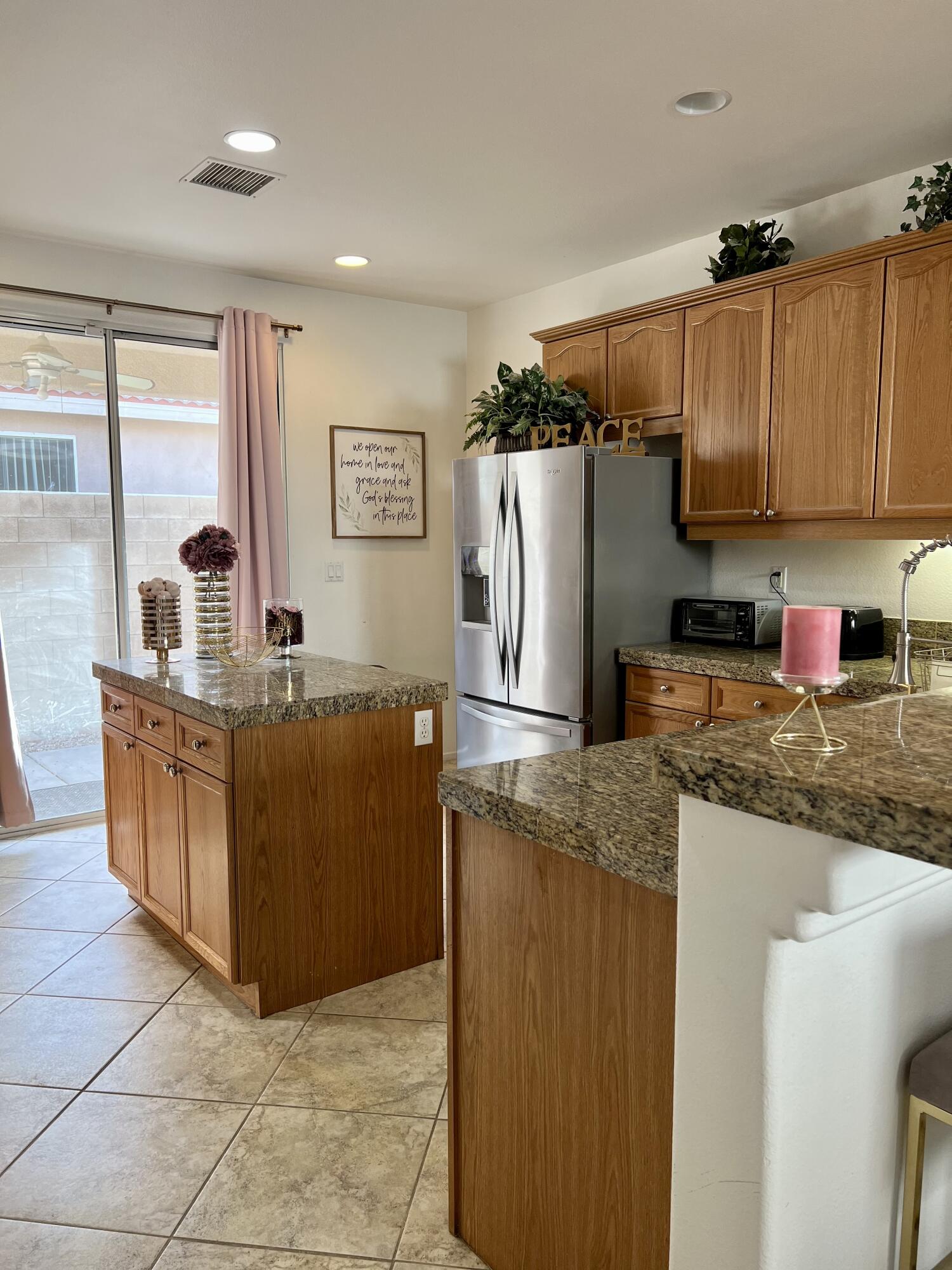 46450 Calle Raphael Indio, CA 92201 - Photo 11 of 33 a kitchen with stainless steel appliances granite countertop a refrigerator a stove and a sink