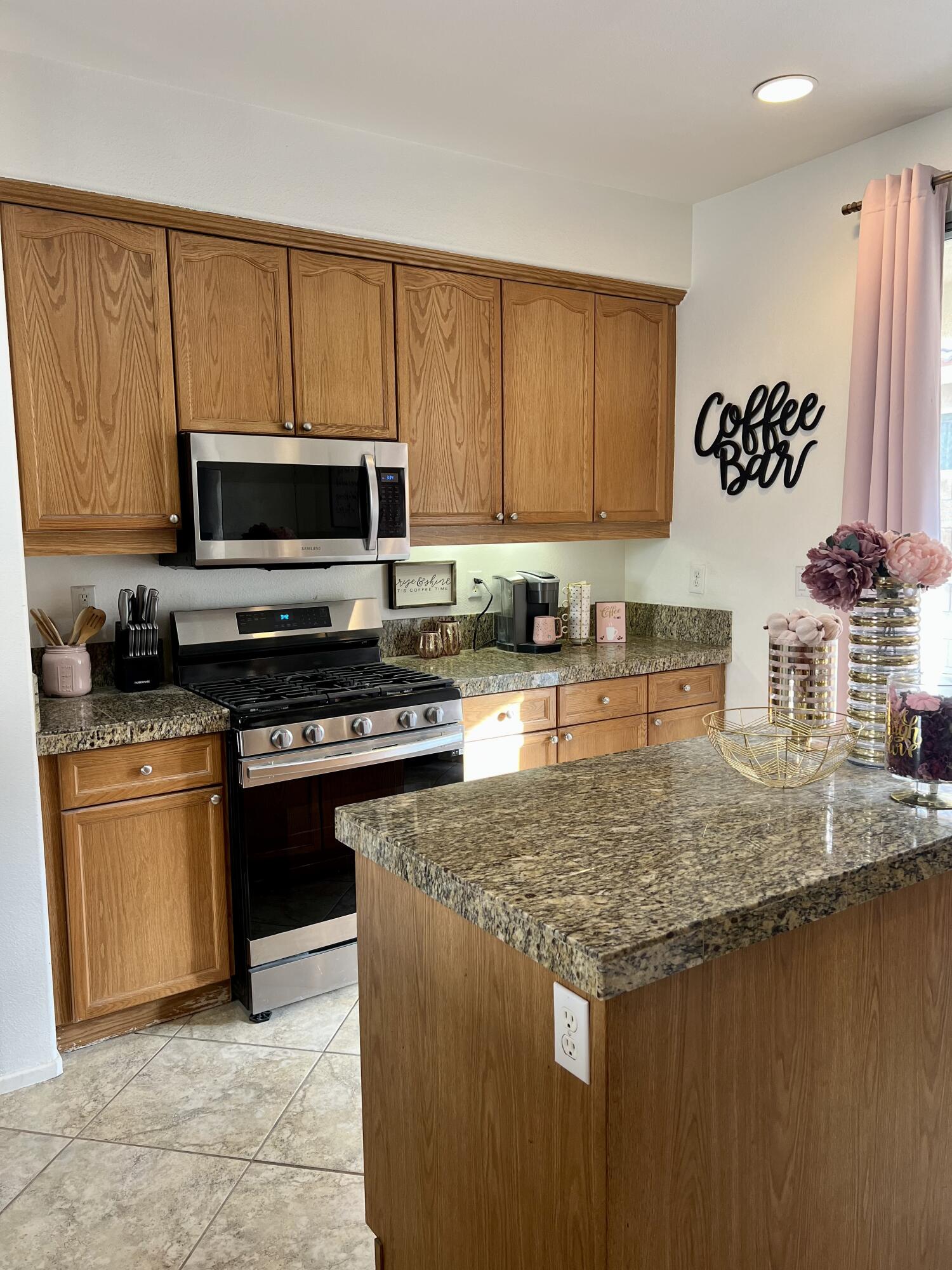 46450 Calle Raphael Indio, CA 92201 - Photo 12 of 33 a kitchen with stainless steel appliances granite countertop a stove a sink and a microwave