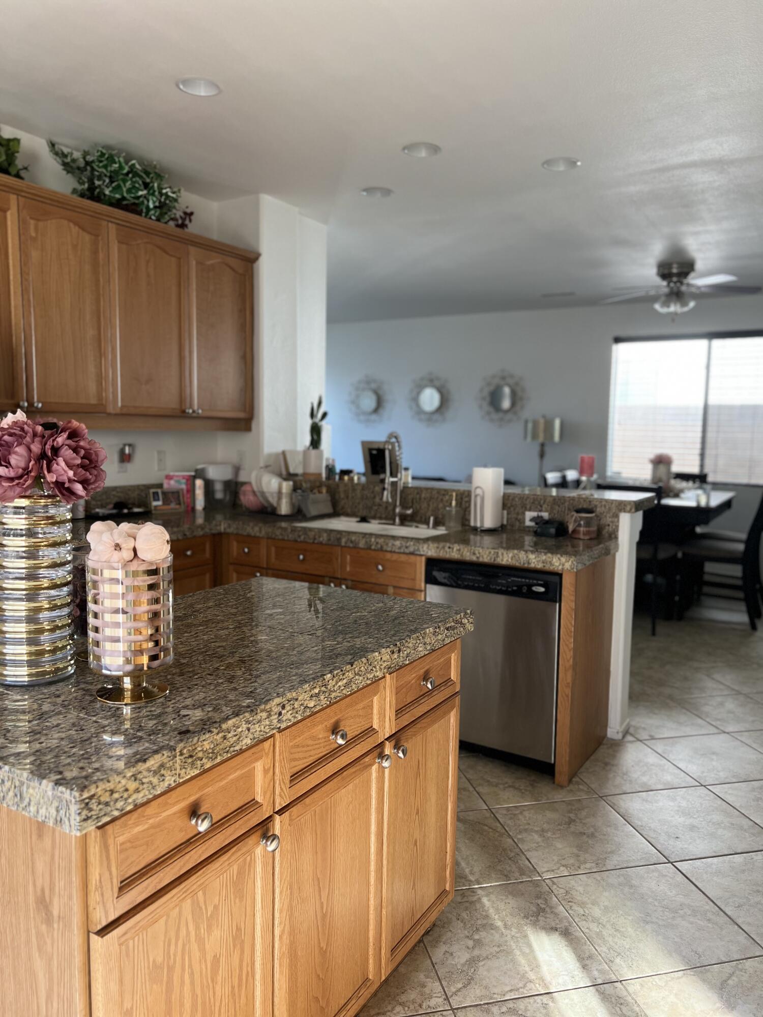 46450 Calle Raphael Indio, CA 92201 - Photo 14 of 33 a kitchen with kitchen island granite countertop a sink counter and cabinets