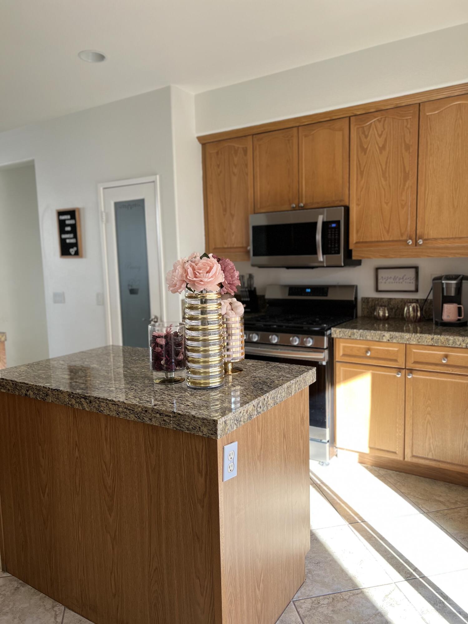 46450 Calle Raphael Indio, CA 92201 - Photo 15 of 33 a kitchen with stainless steel appliances granite countertop a stove a sink and a microwave