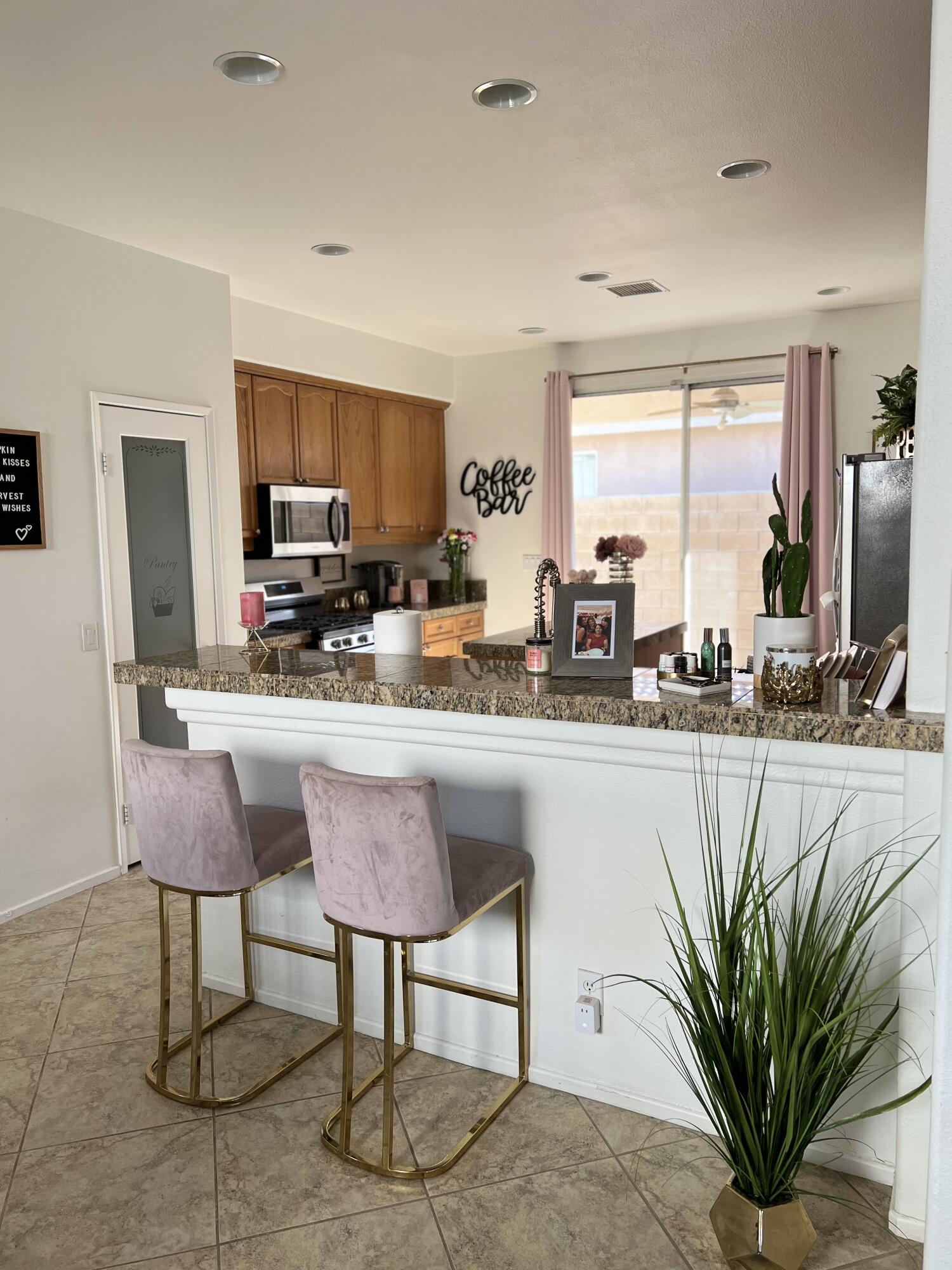 46450 Calle Raphael Indio, CA 92201 - Photo 16 of 33 a kitchen with stainless steel appliances a sink a counter top space cabinets and a potted plant