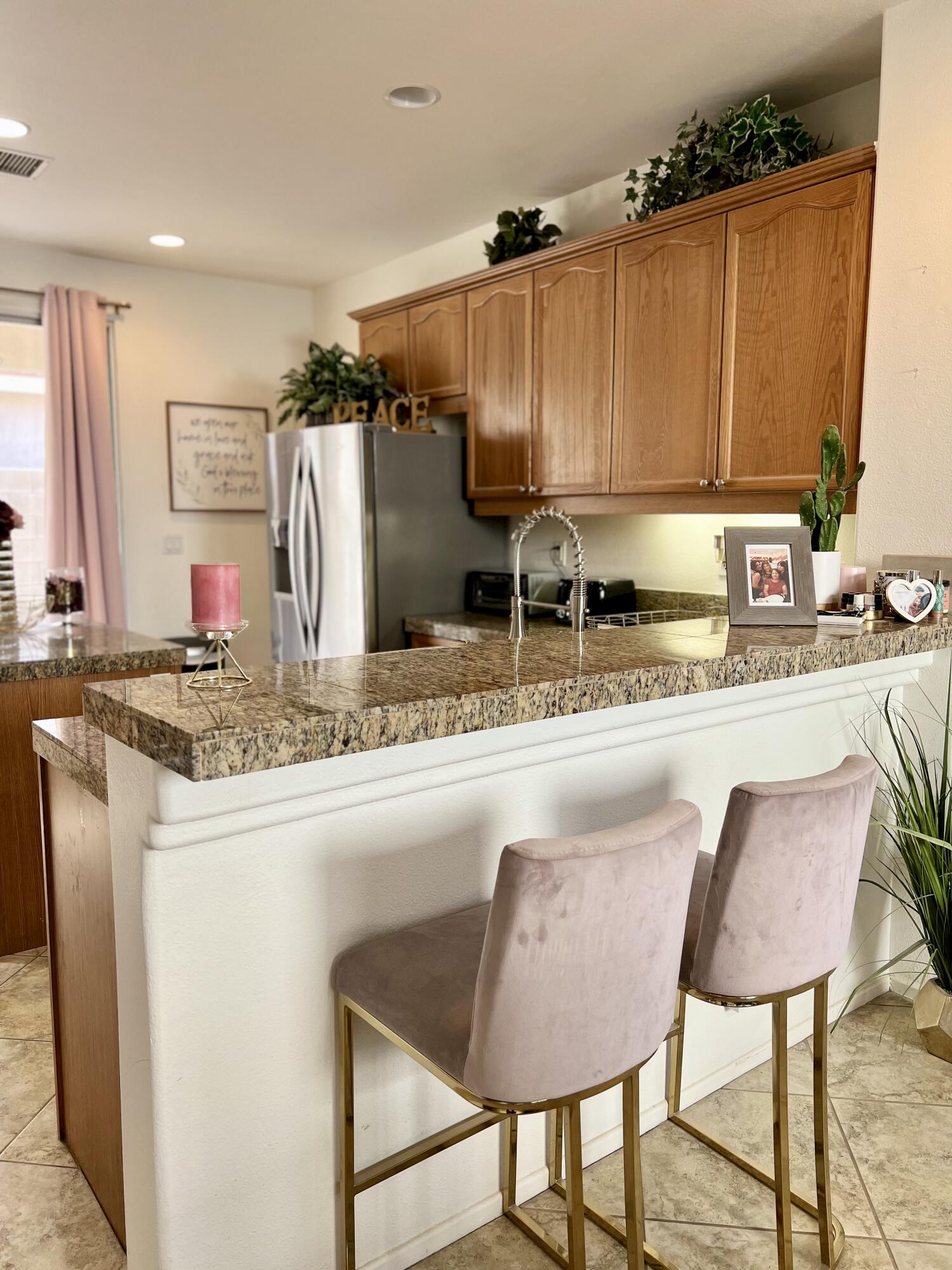 46450 Calle Raphael Indio, CA 92201 - Photo 17 of 33 a kitchen with kitchen island granite countertop a table and chairs