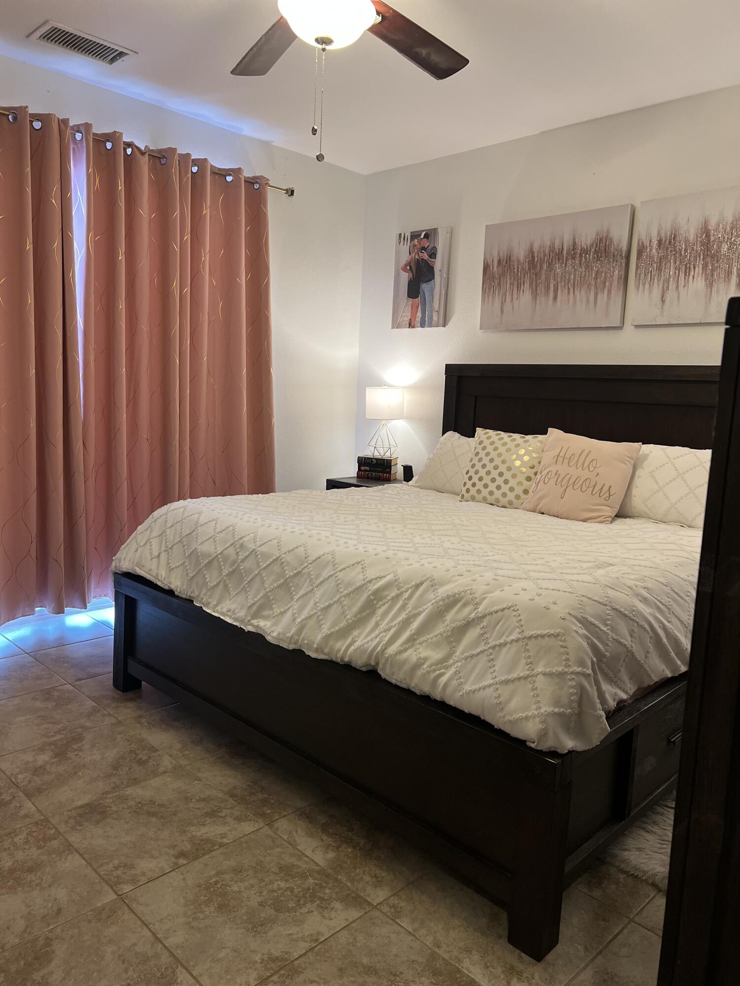 46450 Calle Raphael Indio, CA 92201 - Photo 18 of 33 a large bed sitting in a bedroom next to a chandelier