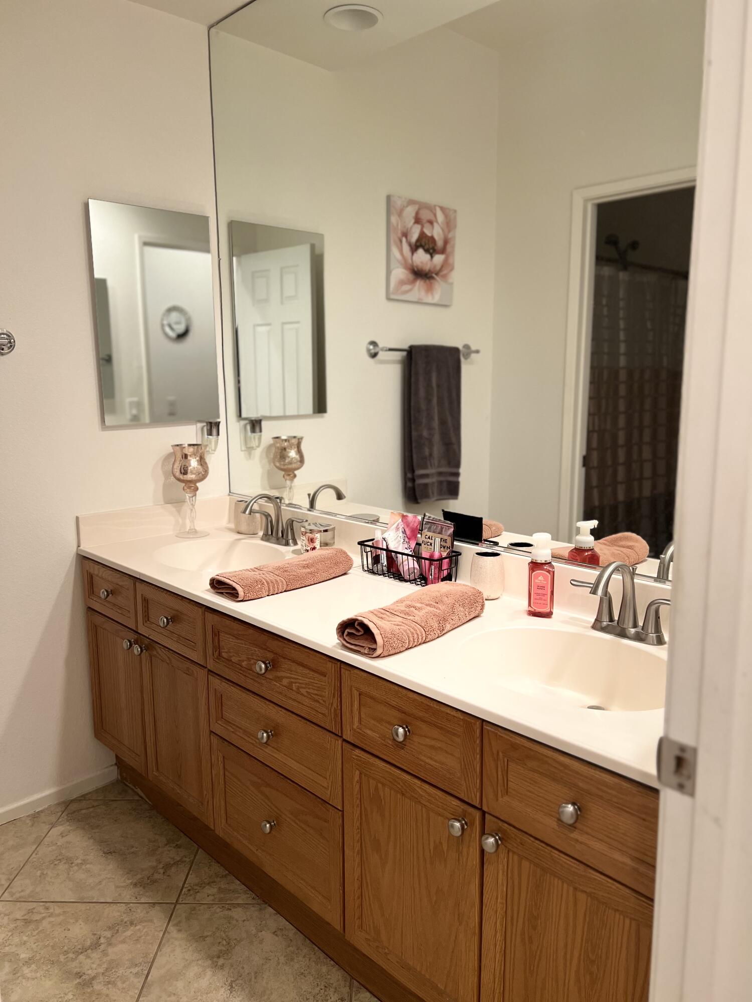 46450 Calle Raphael Indio, CA 92201 - Photo 22 of 33 a bathroom with a double vanity sink and a mirror