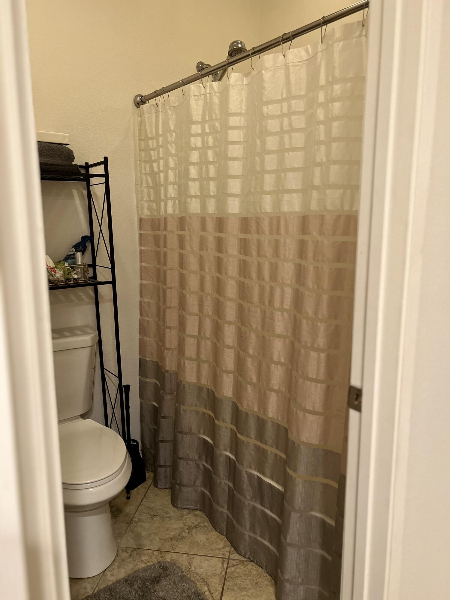 46450 Calle Raphael Indio, CA 92201 - Photo 23 of 33 a bathroom with a toilet and shower curtain