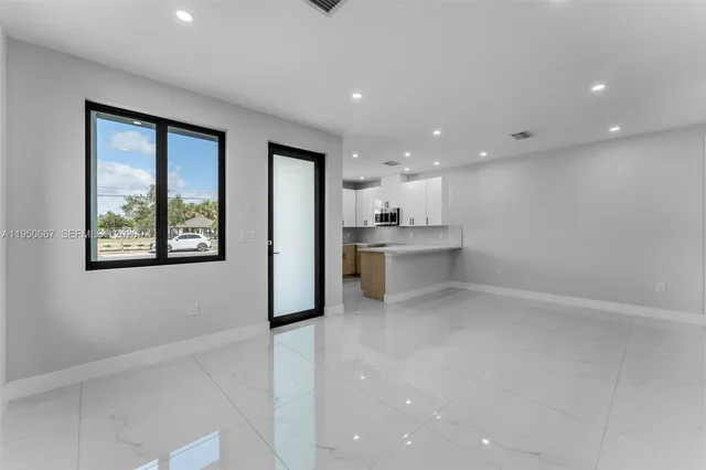 a view of a kitchen with a sink and an entryway
