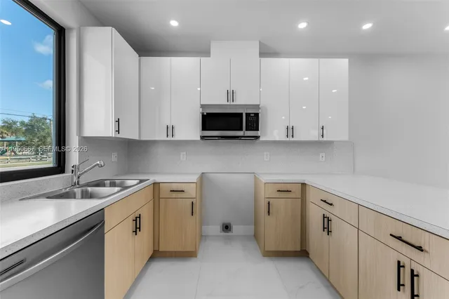 a view of a kitchen with sink and cabinets