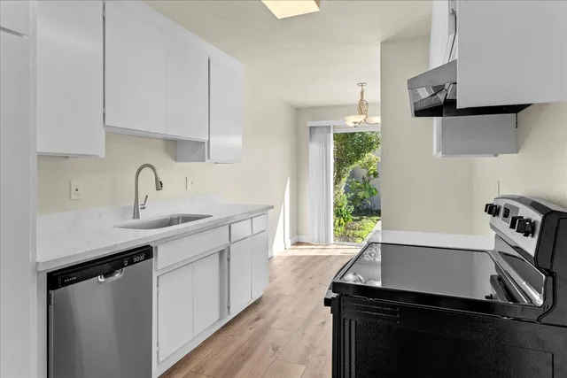 a kitchen with a sink appliances and cabinets