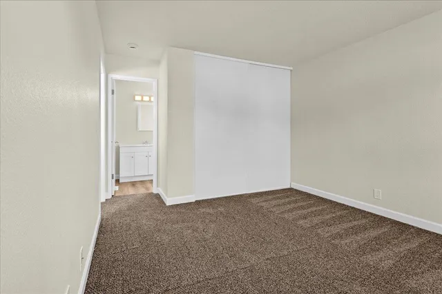 an empty room with closet area