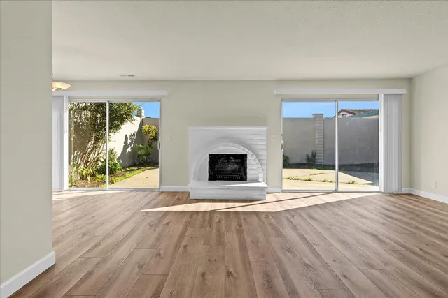 wooden floor fireplace and natural light in room