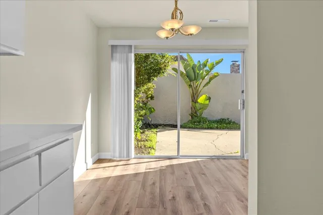 a view of an entryway with wooden floor