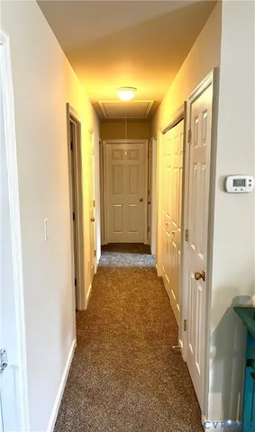 a view of a hallway with wooden shelves