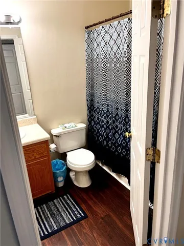 a bathroom with a toilet and a shower curtain