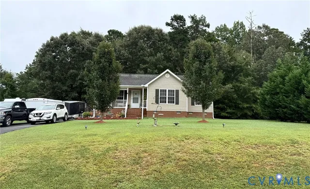 a view of a white house in middle of the green field