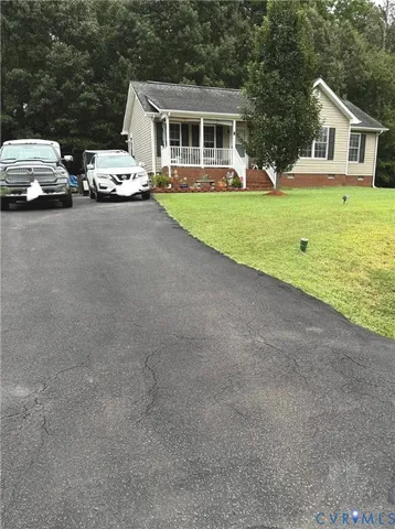 a front view of a house with a garden and yard