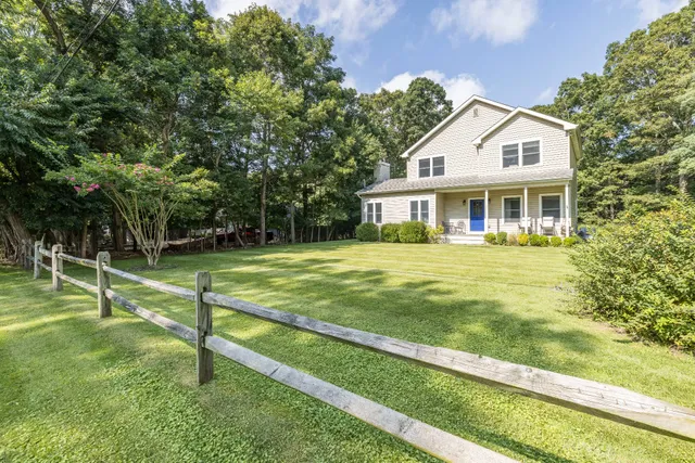 a front view of a house with a yard table and chairs
