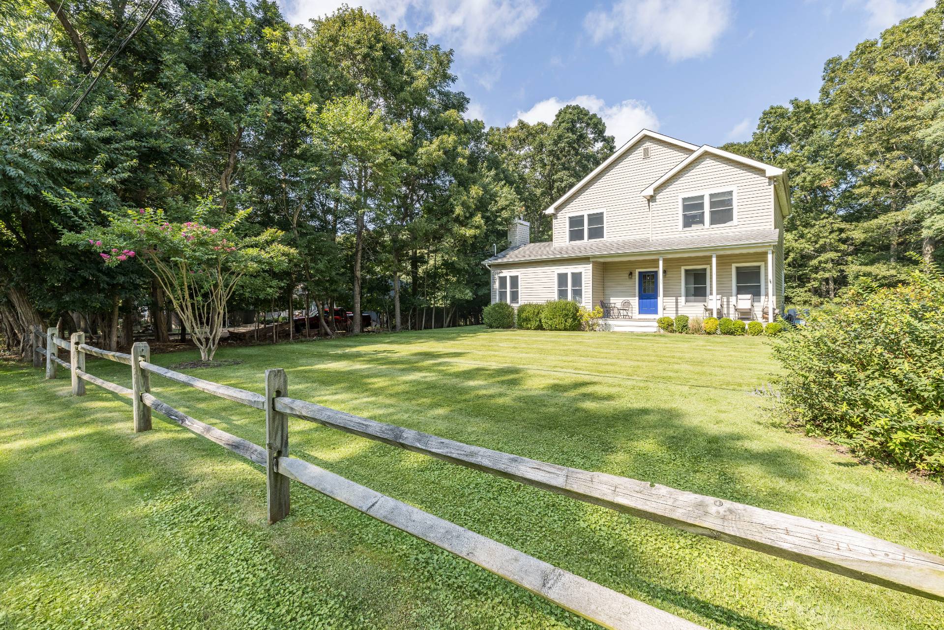 a front view of a house with a yard table and chairs