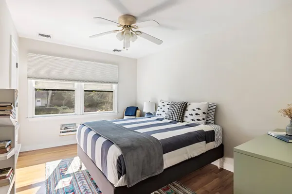 a bedroom with a bed and a chandelier