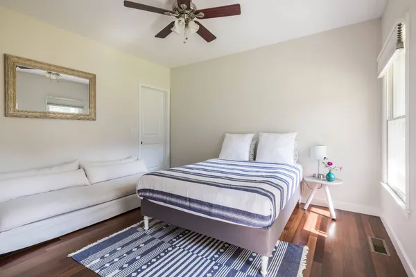 a bedroom with a bed and wooden floor