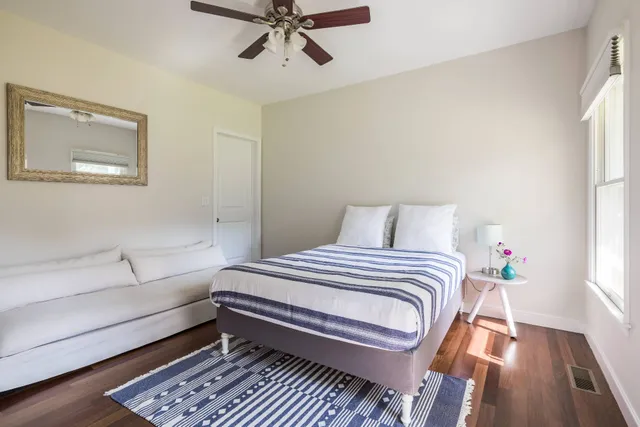 a bedroom with a bed and wooden floor