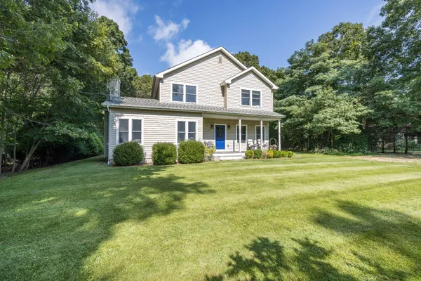 a front view of a house with a yard table and chairs