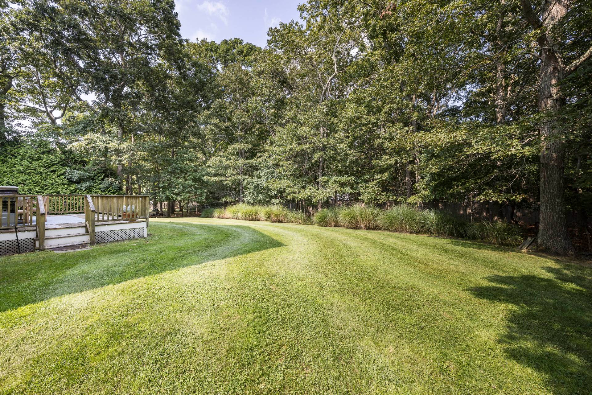 35 Glade Road East Hampton, NY 11937 - Photo 4 of 16 a view of a field with trees in the background