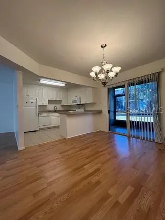 a view of a kitchen with a kitchen island wooden floor and a fireplace