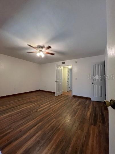501 Southwest 75th Street, Unit H12 Gainesville, FL 32607 - Photo 9 of 10 a view of an empty room with wooden floor