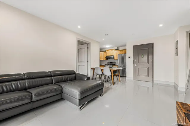 a living room with furniture and kitchen view