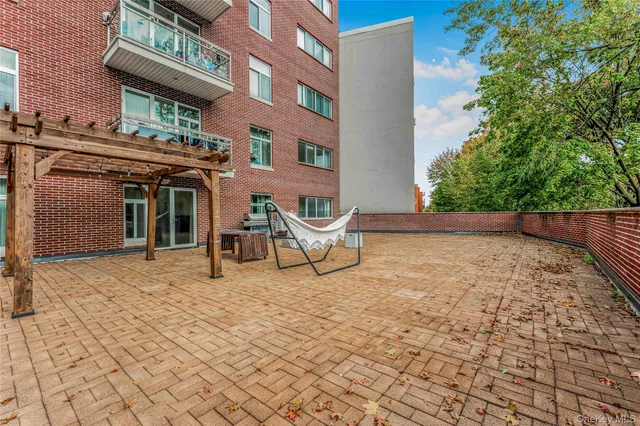 a view of a building with backyard porch and sitting area