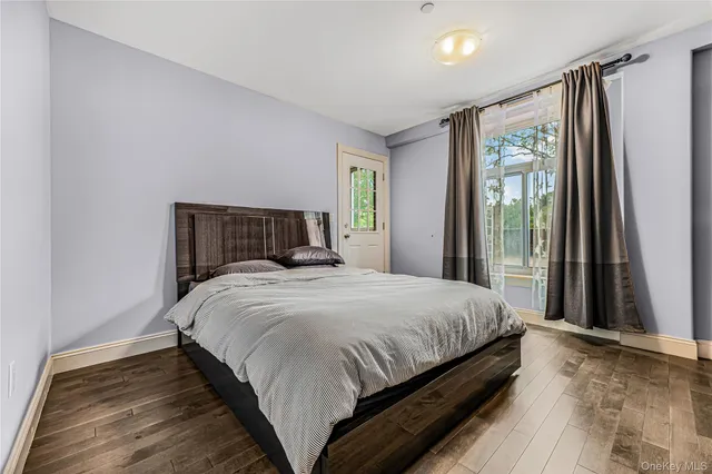 a bedroom with a large bed and a window