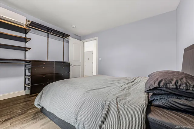 a bedroom with a bed and a mirror