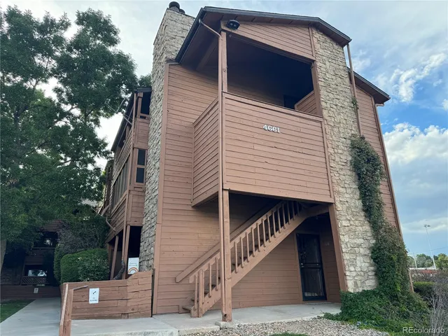 a view of a bedroom with wooden floor and furniture