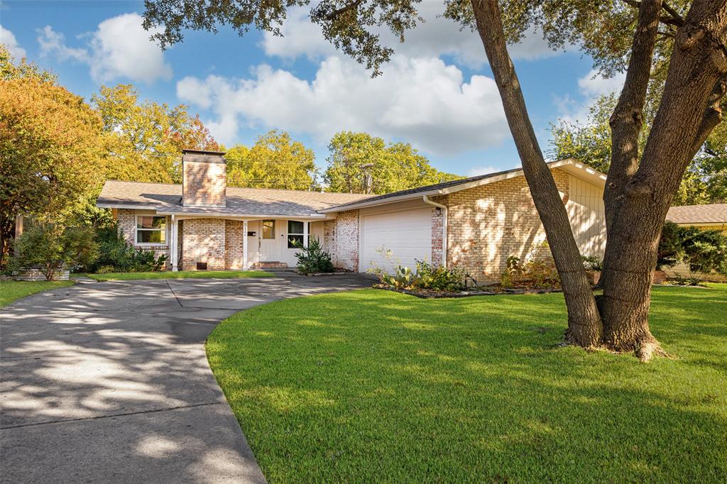 812 Sherbrook Drive Richardson, TX 75080 - Photo 1 of 28 a front view of a house with garden