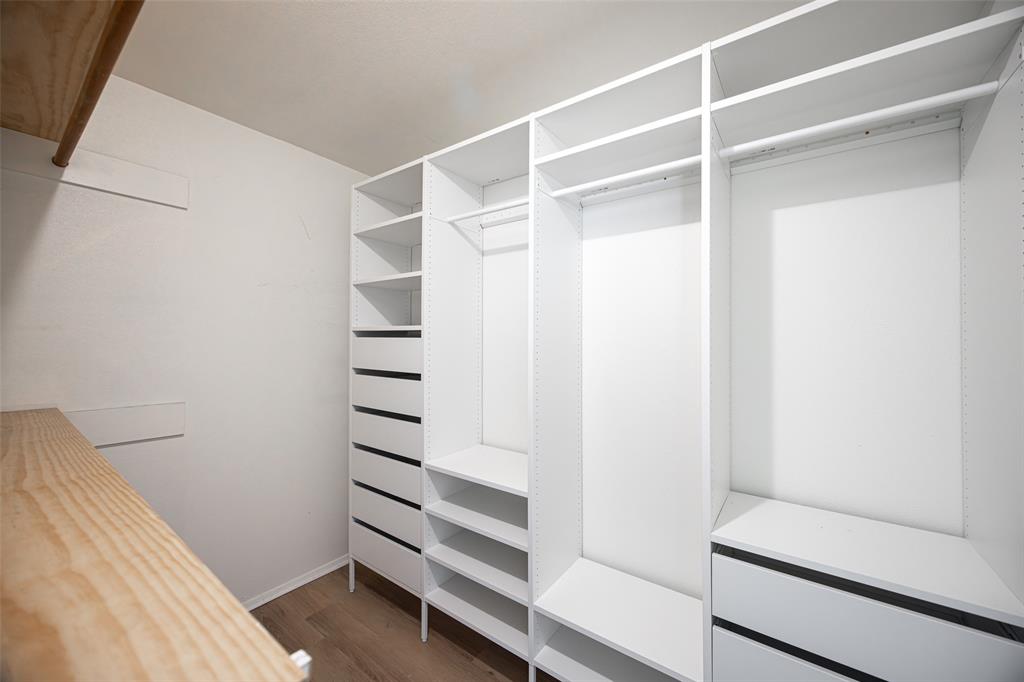 812 Sherbrook Drive Richardson, TX 75080 - Photo 17 of 28 a view of walk in closet with empty racks