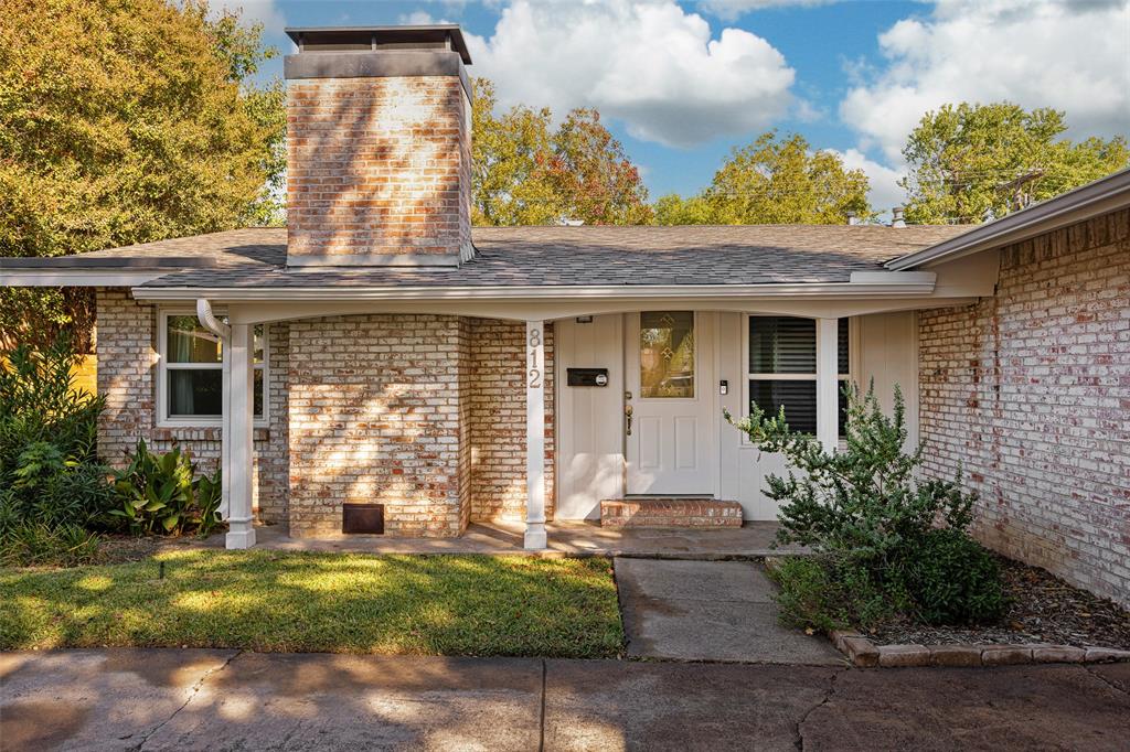 812 Sherbrook Drive Richardson, TX 75080 - Photo 2 of 28 a front view of a house with garden