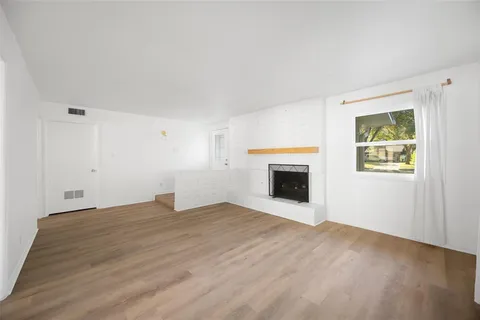 a view of empty room with a fireplace