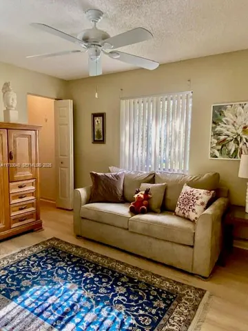 a bathroom with a granite countertop sink toilet mirror and shower