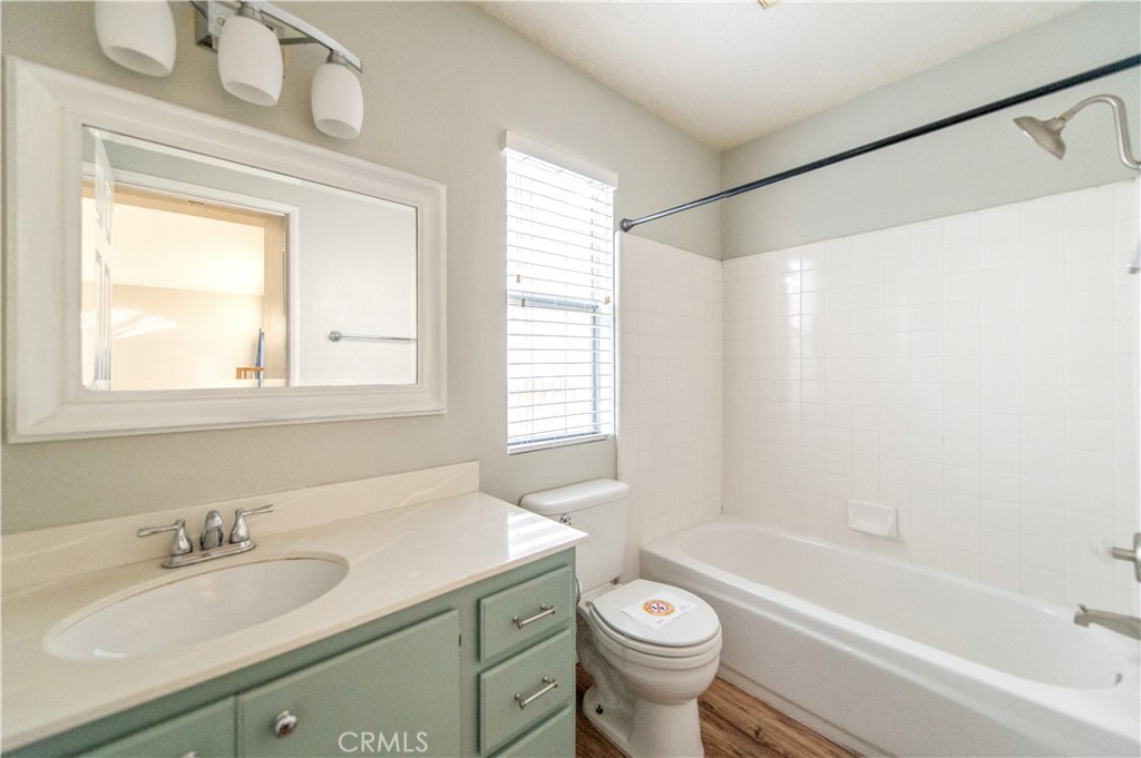 6771 Galveston Place Rancho Cucamonga, CA 91701 - Photo 29 of 38 a bathroom with a granite countertop sink toilet a mirror and a bathtub