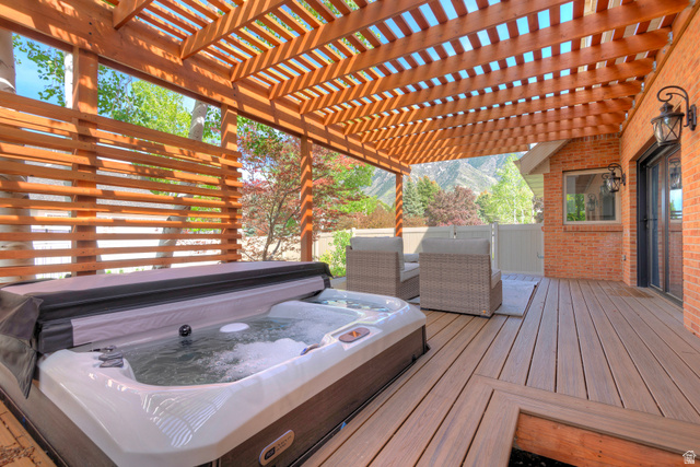 16 Gatehouse Lane Sandy, UT 84092 - Photo 50 of 73 Wooden terrace with a covered hot tub and a mountain view