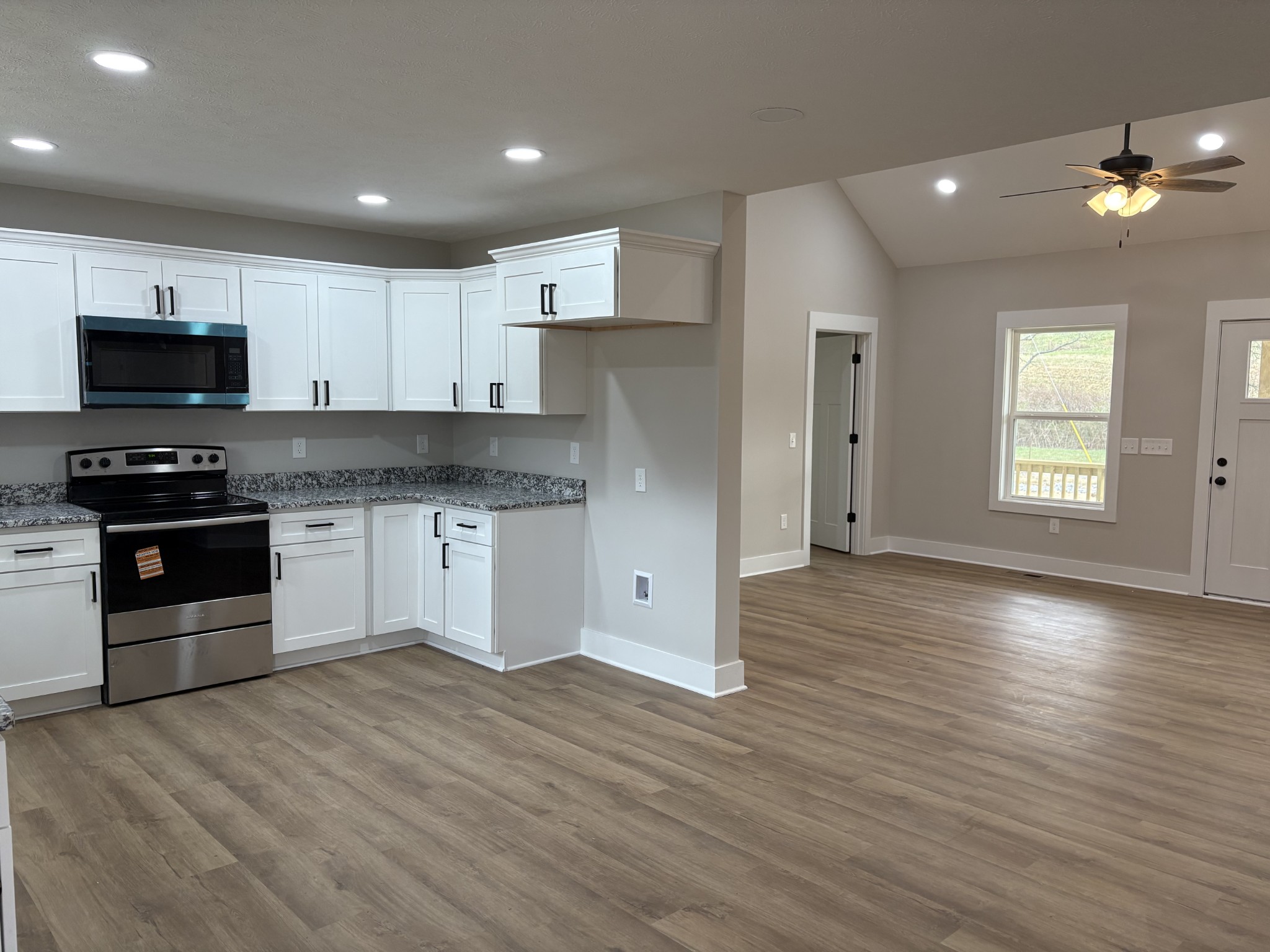 2264 Collier Road Cornersville, TN 37047 - Photo 11 of 20 a kitchen with granite countertop a refrigerator and a stove top oven