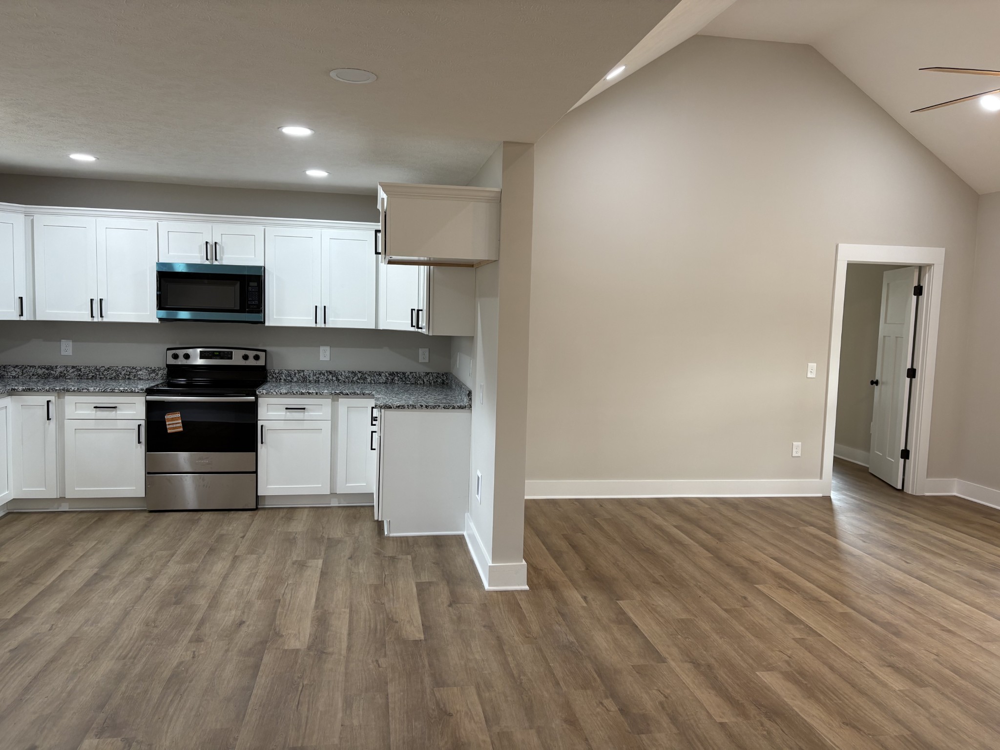 2264 Collier Road Cornersville, TN 37047 - Photo 4 of 20 a kitchen with wooden floors and white appliances