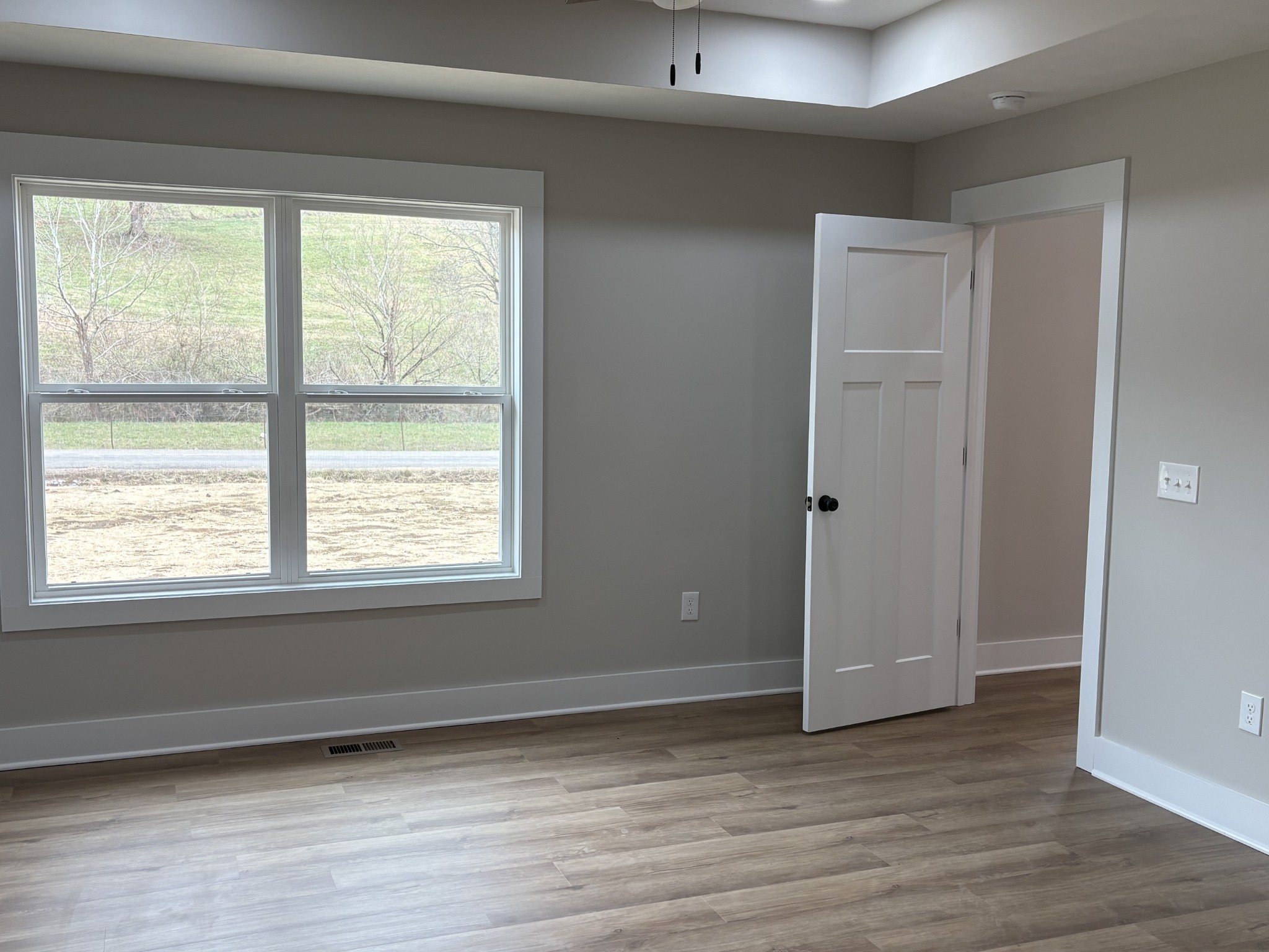 2264 Collier Road Cornersville, TN 37047 - Photo 8 of 20 a view of an empty room with wooden floor and a window
