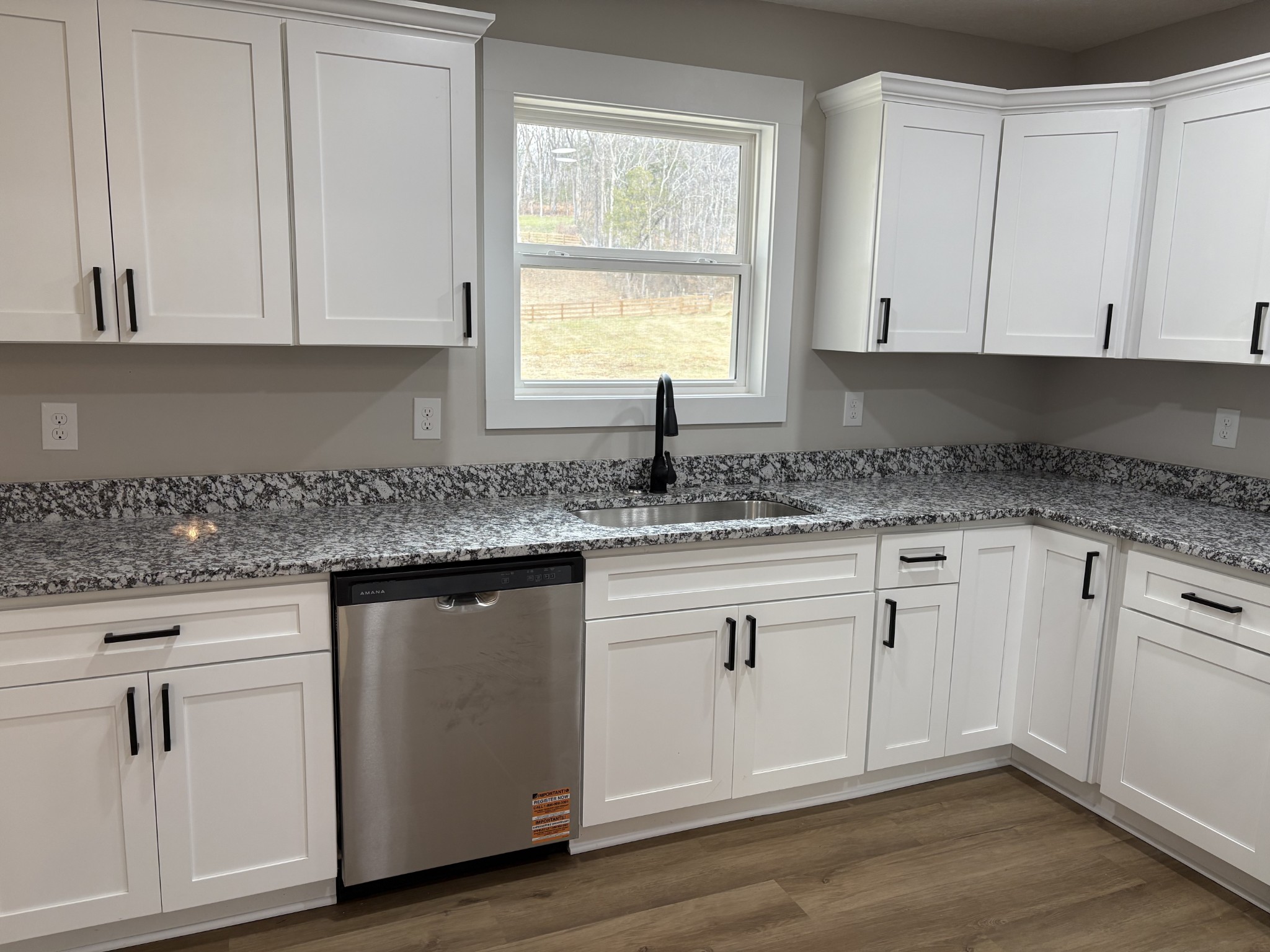 2264 Collier Road Cornersville, TN 37047 - Photo 9 of 20 a kitchen with granite countertop white cabinets and a sink