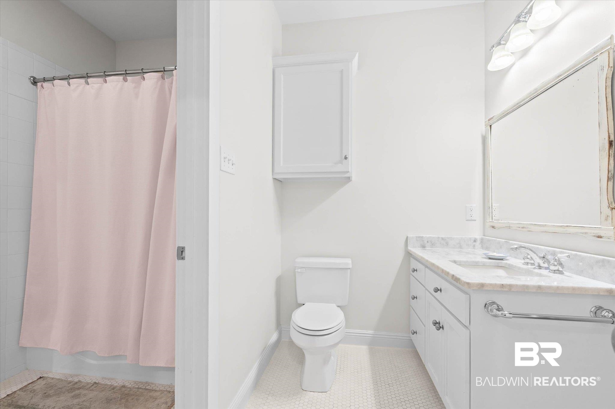 3813 Austill Lane Mobile, AL 36608 - Photo 21 of 37 Bathroom featuring a white vanity with a light-colored countertop, an undermount sink, and a decorative framed mirror