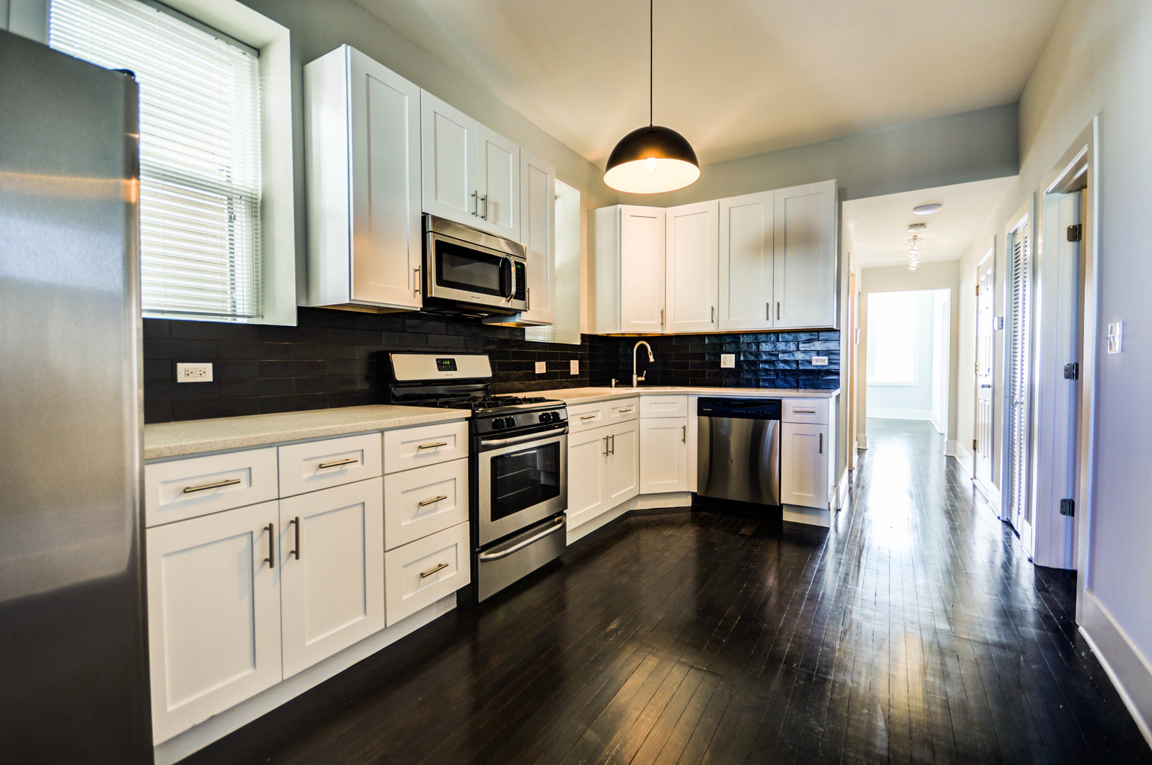 1724 West 21st Street, Unit 3F Chicago, IL 60608 - Photo 2 of 13 a kitchen with white cabinets and white appliances