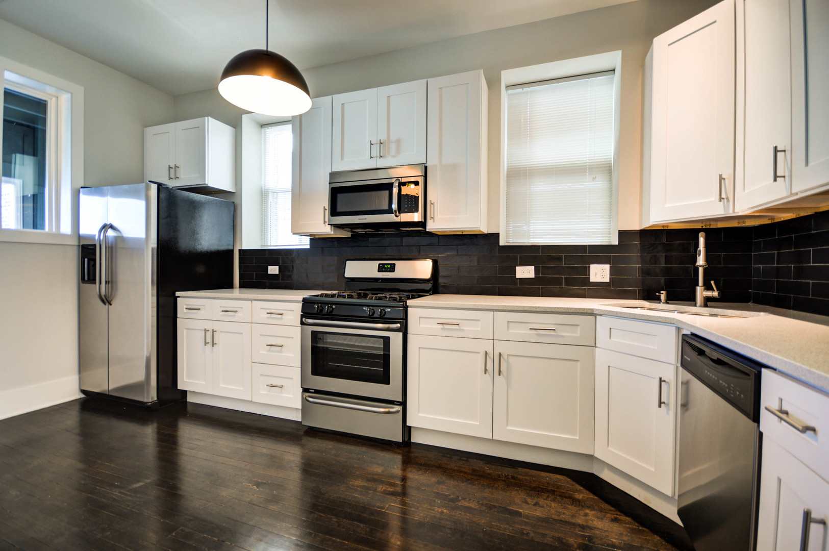 1724 West 21st Street, Unit 3F Chicago, IL 60608 - Photo 3 of 13 a kitchen with stainless steel appliances granite countertop a stove a sink and a microwave