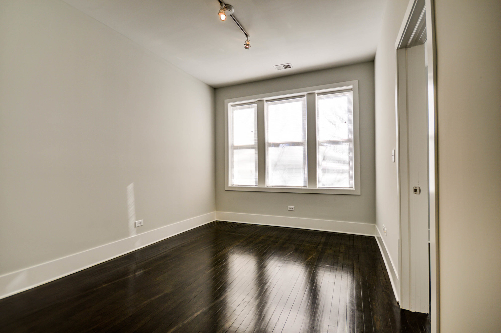 1724 West 21st Street, Unit 3F Chicago, IL 60608 - Photo 5 of 13 an empty room with wooden floor and windows